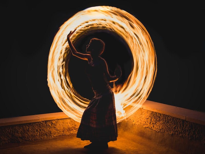 Woman juggling fire.